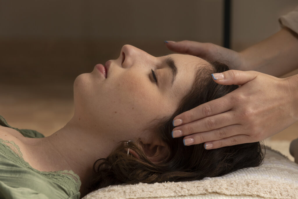 Reiki energy healing session with practitioner's hands above client at Austin Transformational Health