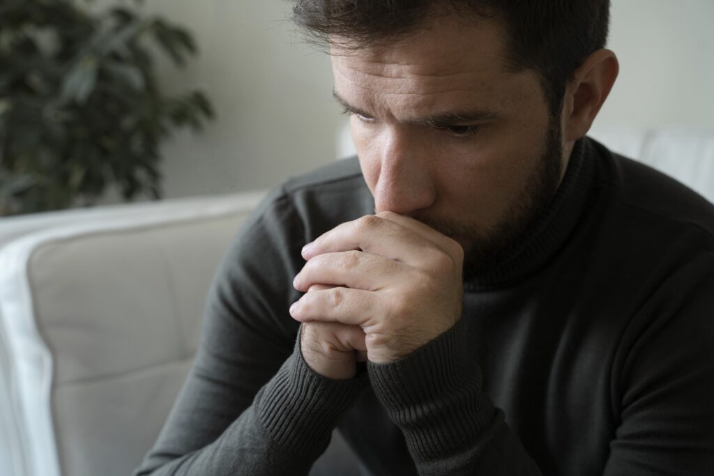 Person sitting at table with food looking emotionally flat, illustrating Ozempic anhedonia and mood side effects