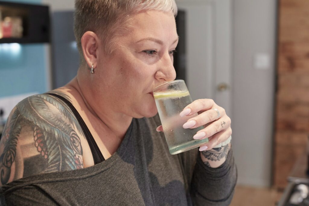 Person drinking water with concern illustrating Ozempic teeth dental side effects including dry mouth and enamel erosion
