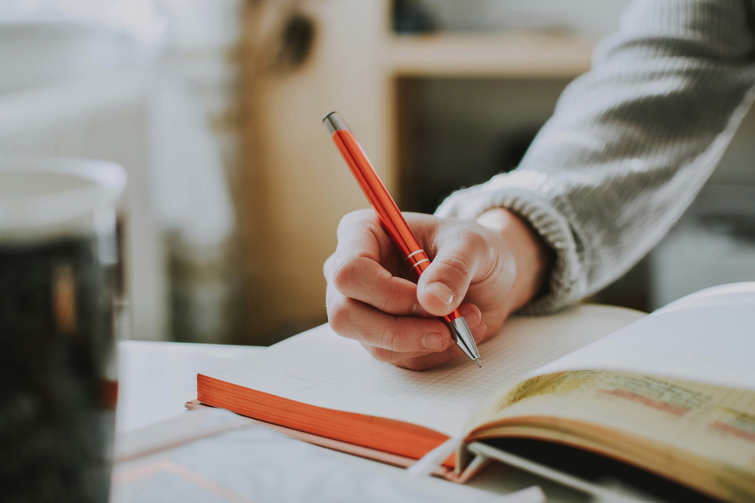 Person tracking their gut health progress with a journal